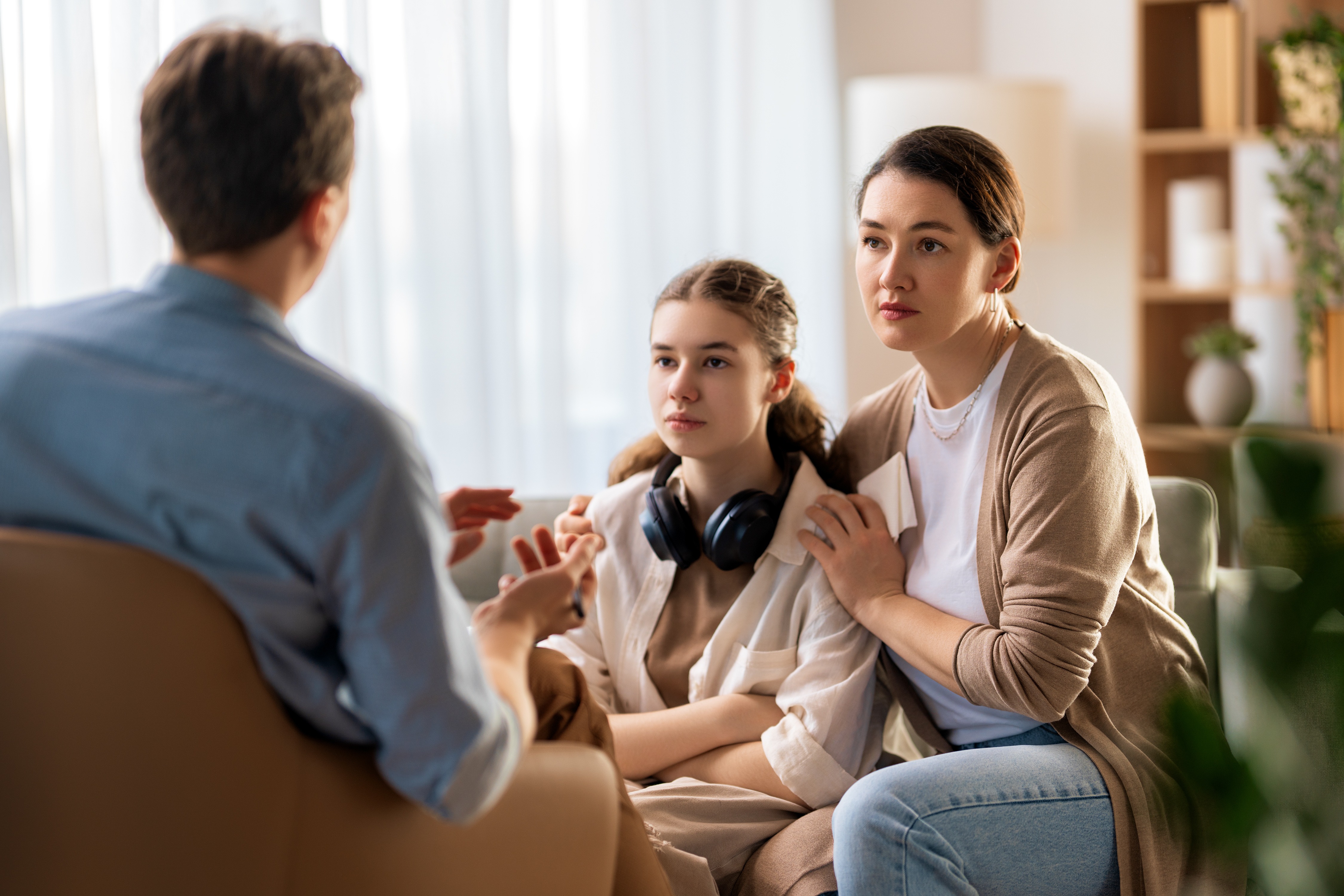 Teen and her mother meeting with an ABA professional